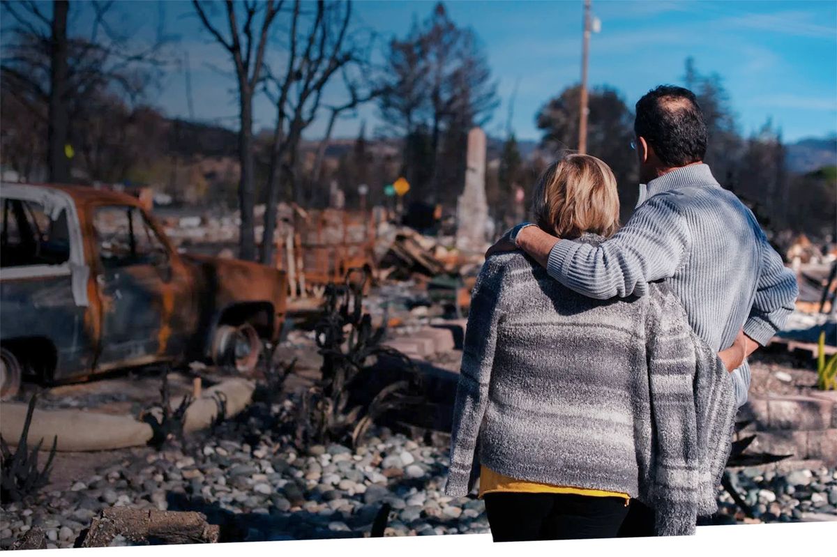 Photo of residents surveying the aftermath of a wildfire