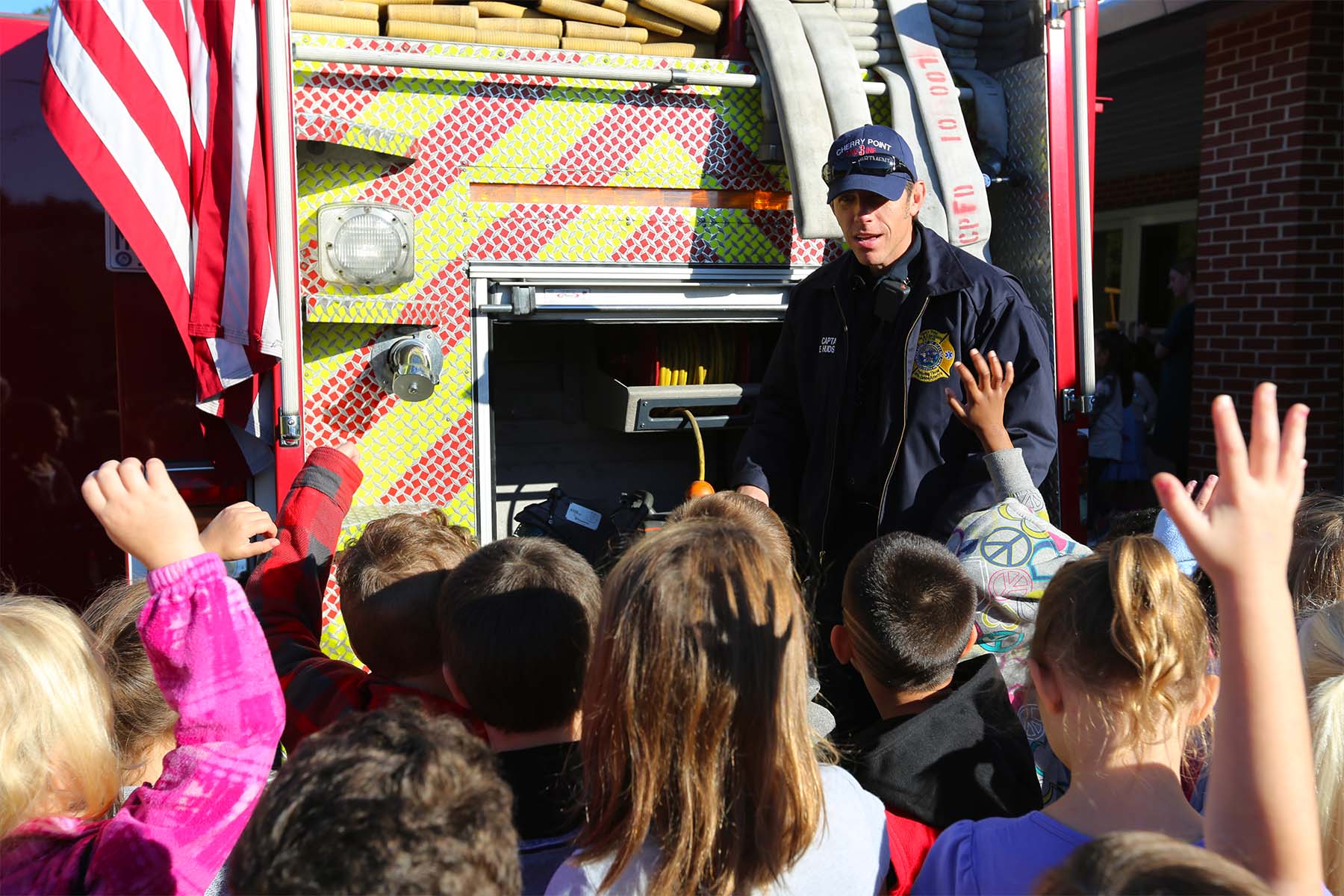 firefighter talking with children