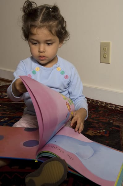 girl next to electrical outlet with covers