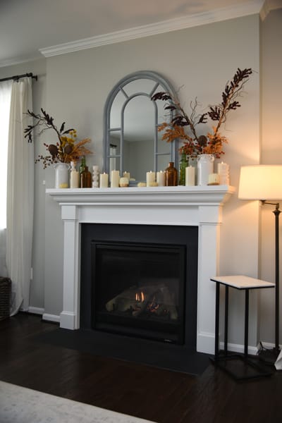 flameless candles arranged on a fireplace mantel