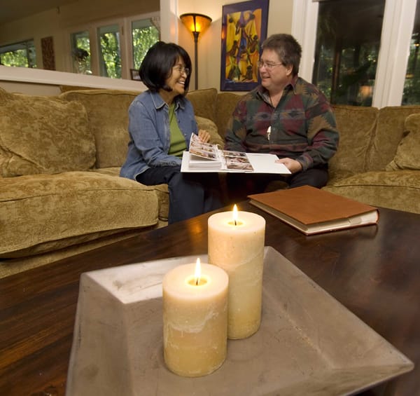 candles on a table, people sitting on a couch