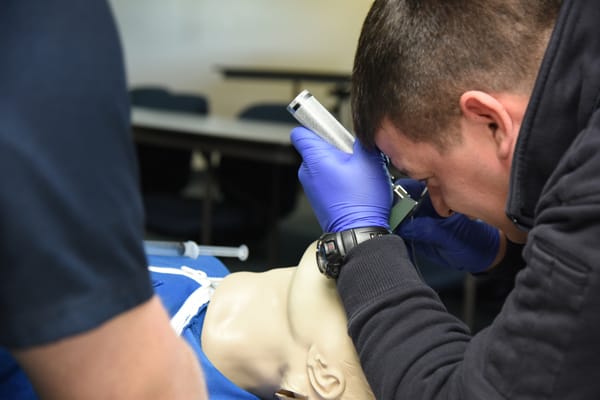 EMTs intubating training mannequin