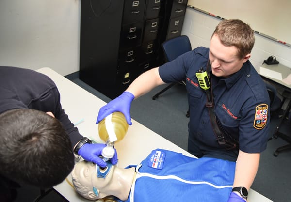EMTs intubating training mannequin