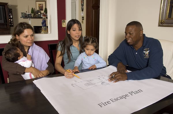 firefighter helping a family make a fire escape plan