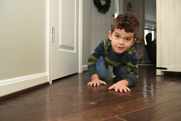 boy practicing crawling low under smoke