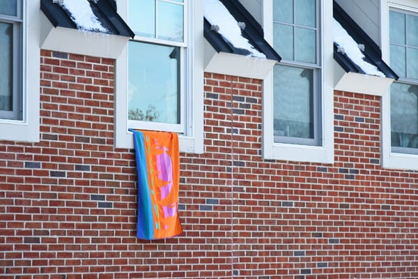 a towel hanging out of a window to alert firefighters