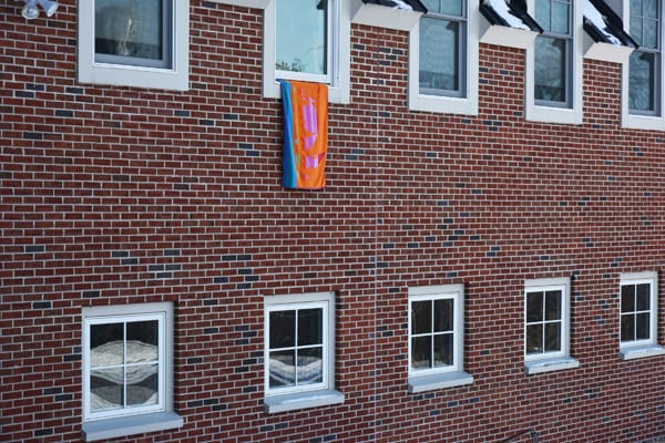 a towel hanging out of a window to alert firefighters