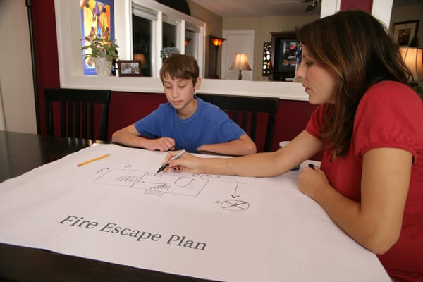 mom and son making a fire escape plan