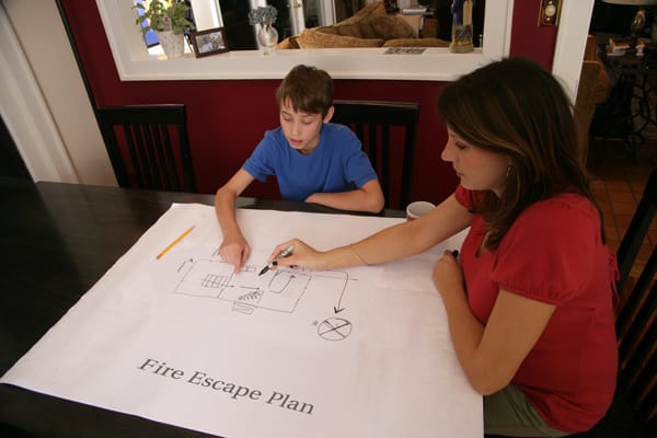 mom and son making a fire escape plan