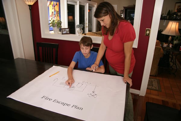 mom and son making a fire escape plan