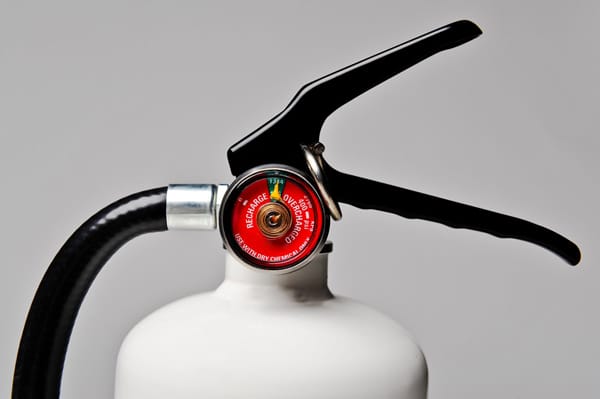 closeup of fire extinguisher gauge and lever