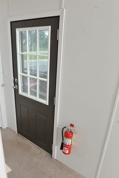 fire extinguisher hanging on a garage wall