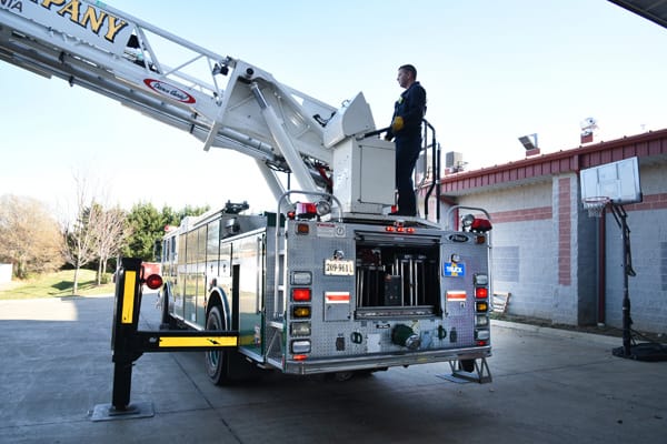 firefighter operating a ladder truck