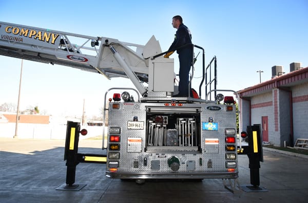 firefighter operating a ladder truck