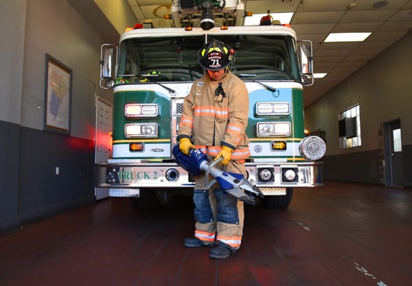 firefighter holding jaws-of-life