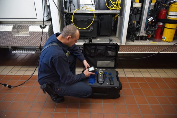 firefighter checking equipment in case