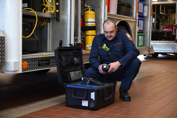 firefighter checking equipment in case