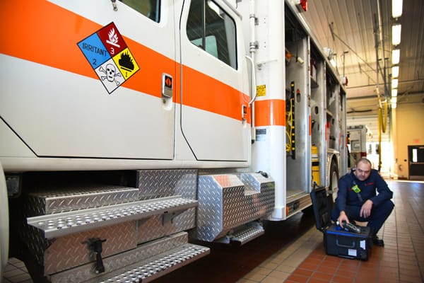 firefighter checking equipment in case