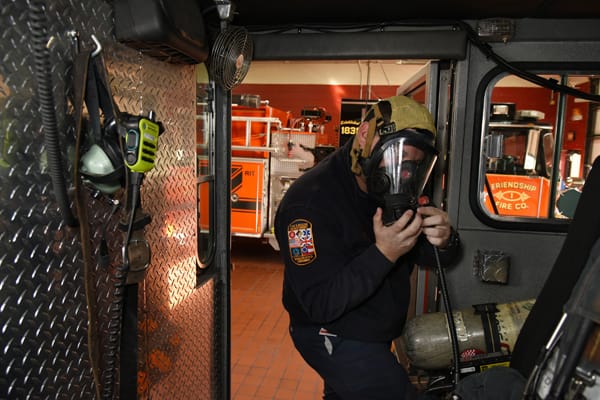 firefighter trying on face piece
