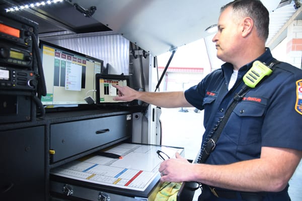 firefighter reviewing incident command information