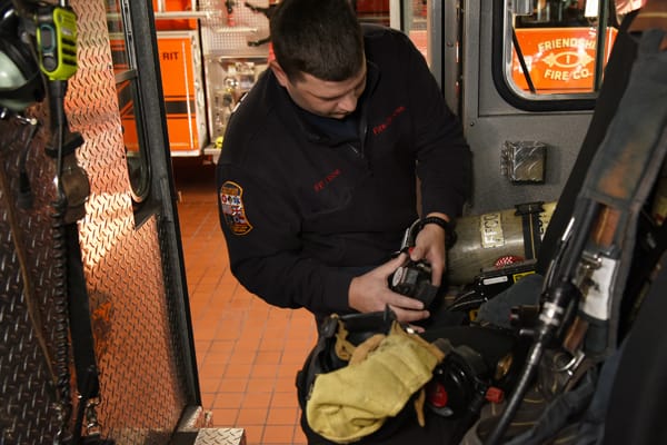 firefighter checking equipment inside cab