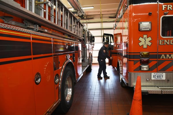 firefighter and apparatus inside station