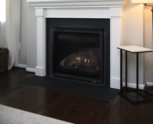 screened fireplace with burning logs