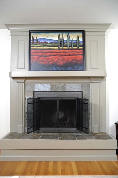 fireplace with framed picture