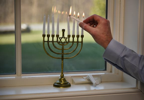 lighting a menorah close up