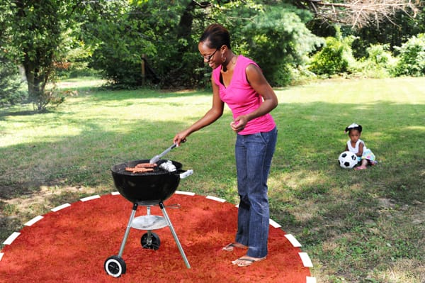 mom grilling while daughter plays more than 3 feet away from the grill