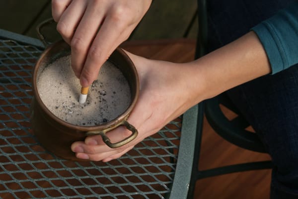 extinguishing a cigarette in sand