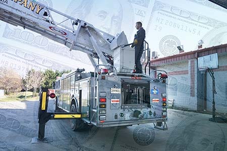 firefighter operating an aerial on a ladder truck