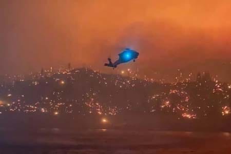 helicopter flying over a wildfire