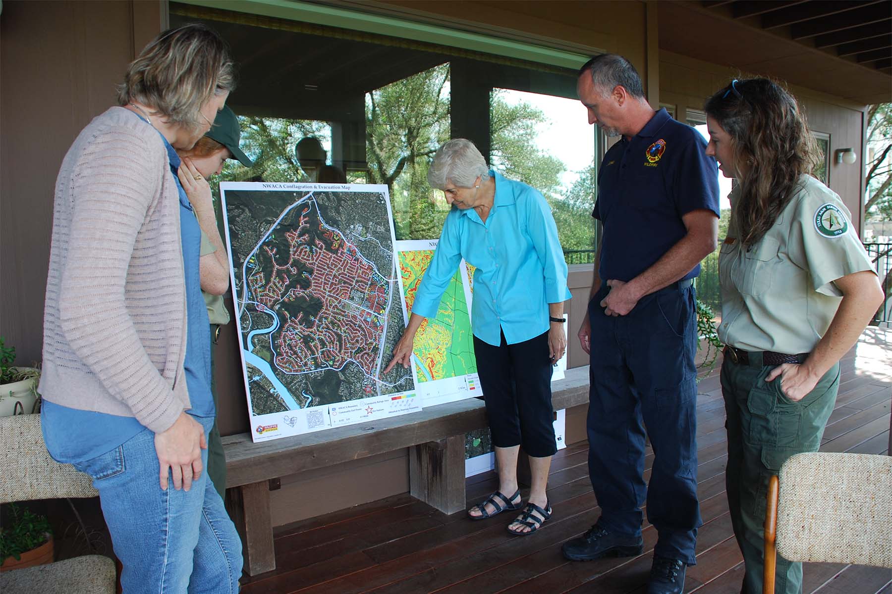 local residents and fire service personnel looking at a map