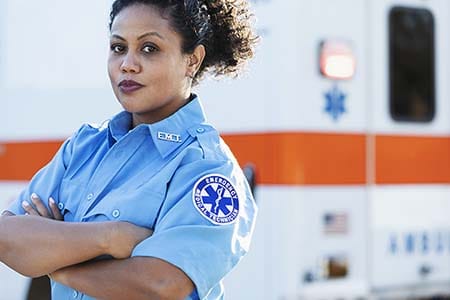 EMT in front of an ambulance