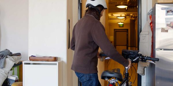 photo of a person storing an e-bike in an apartment