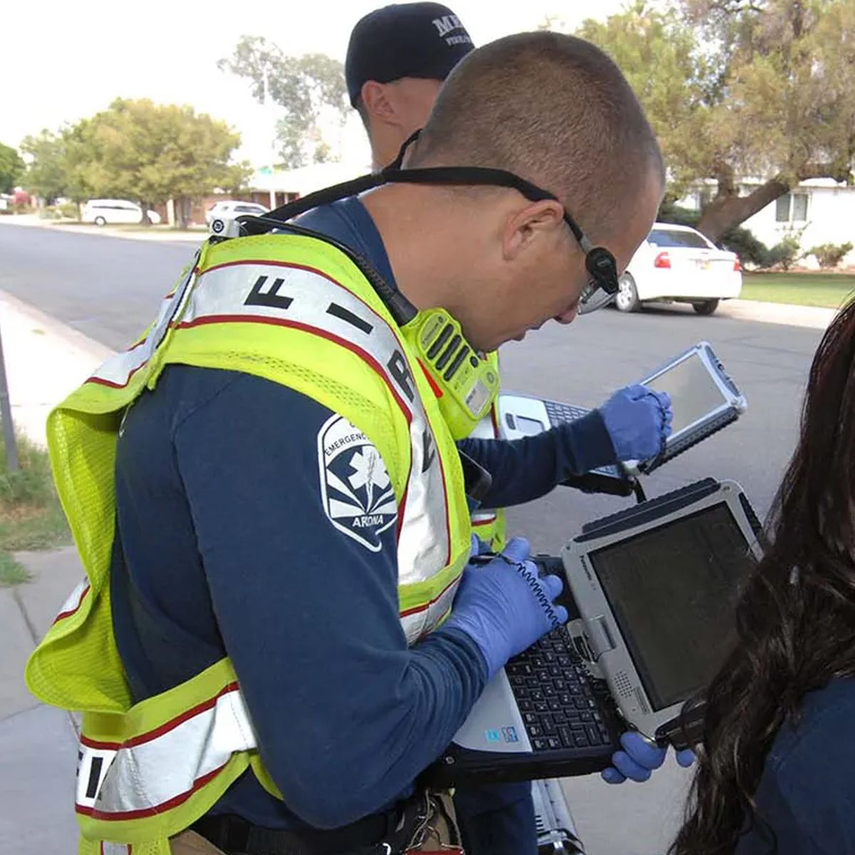 Photo of the fire service using a laptop to enter data.