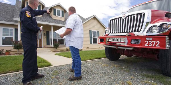 Photo of a firefighter talking with a homeowner