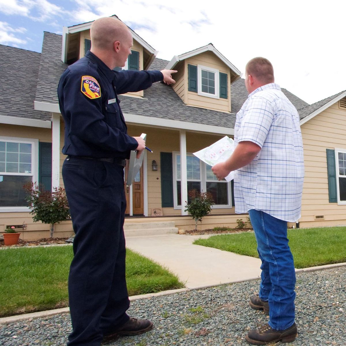 Photo of a firefighter talking with a homeowner
