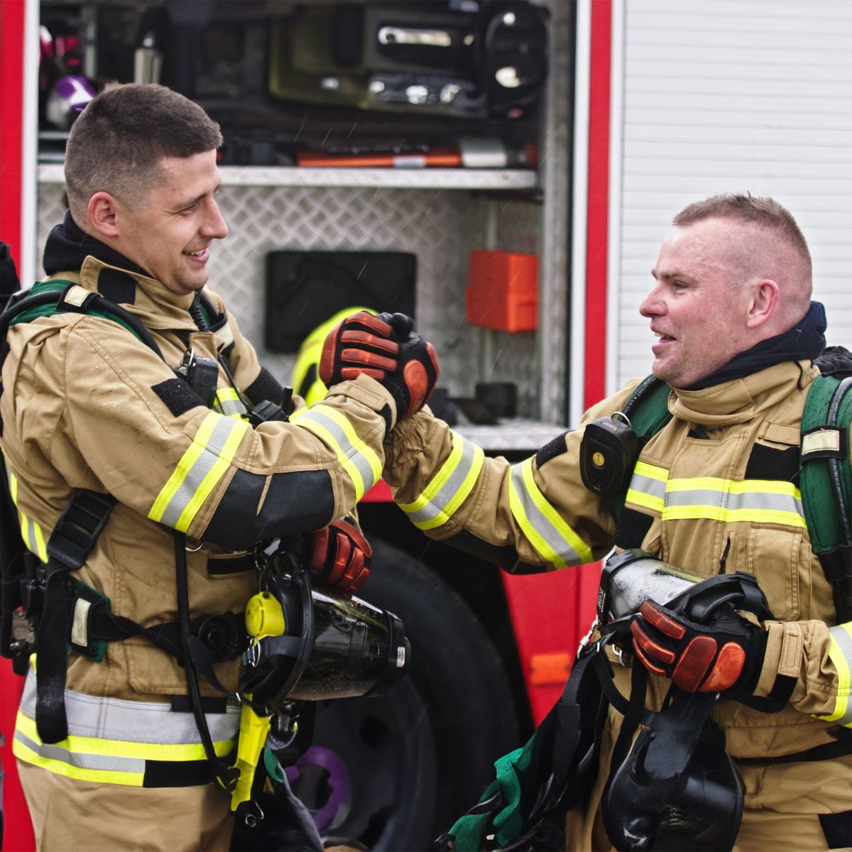2 firefighters celebrating