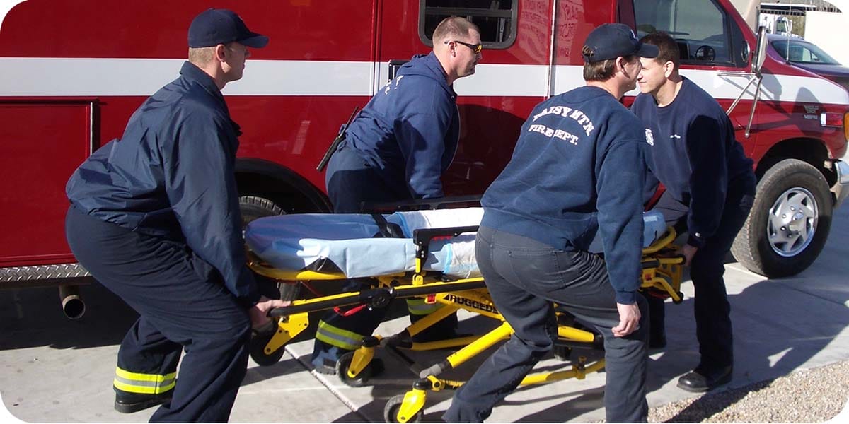 EMTs lifting a stretcher