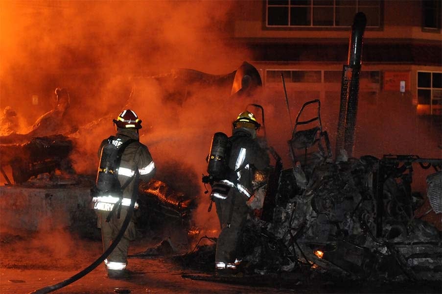 5 firefighters fighting a house fire