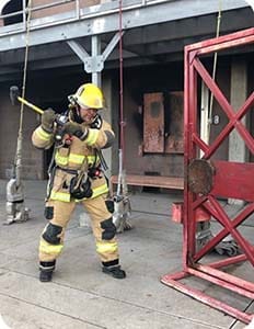 firefighter practicing forcible entry