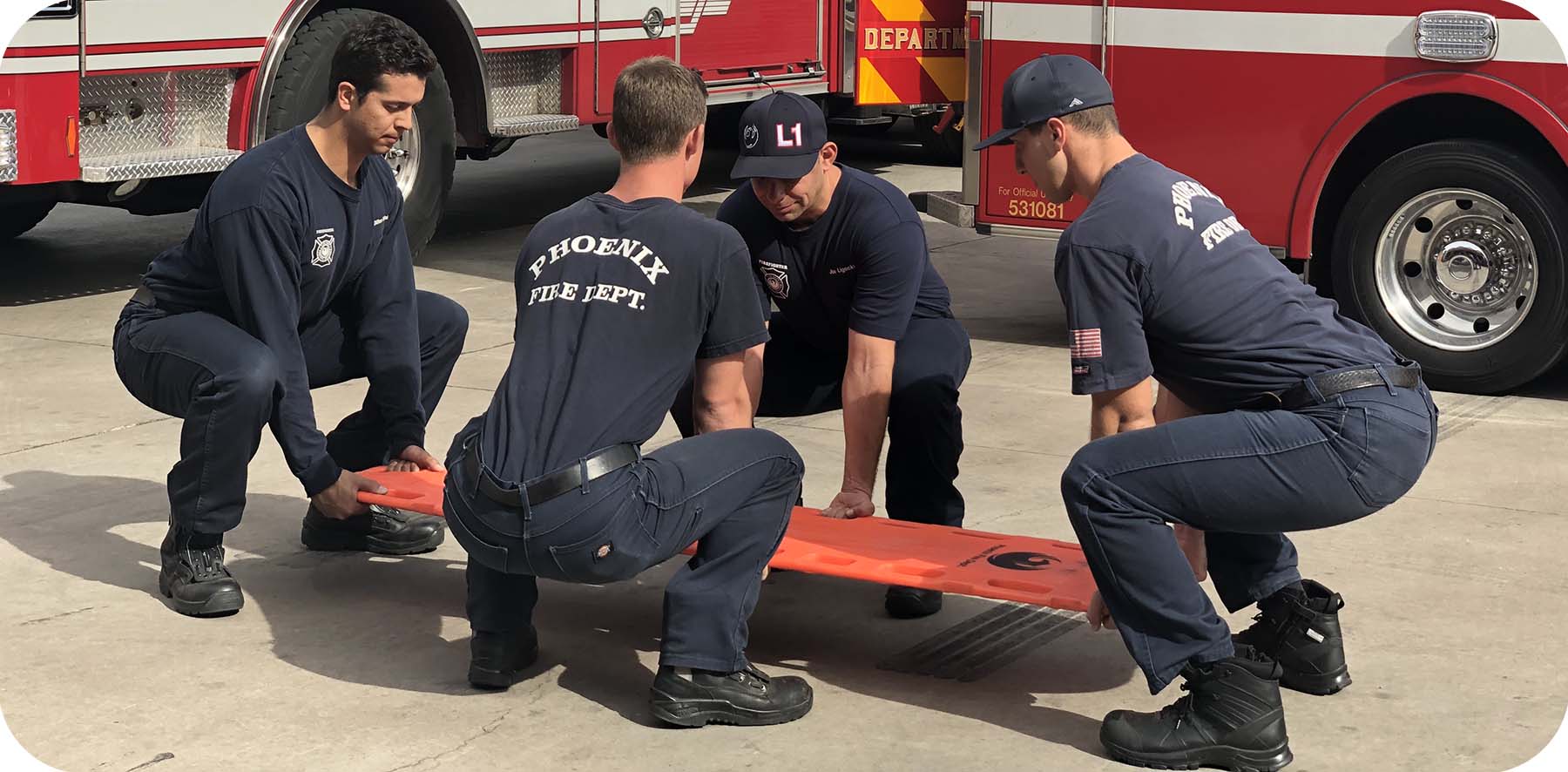 firefighters demonstrating the proper way to lift a backboard