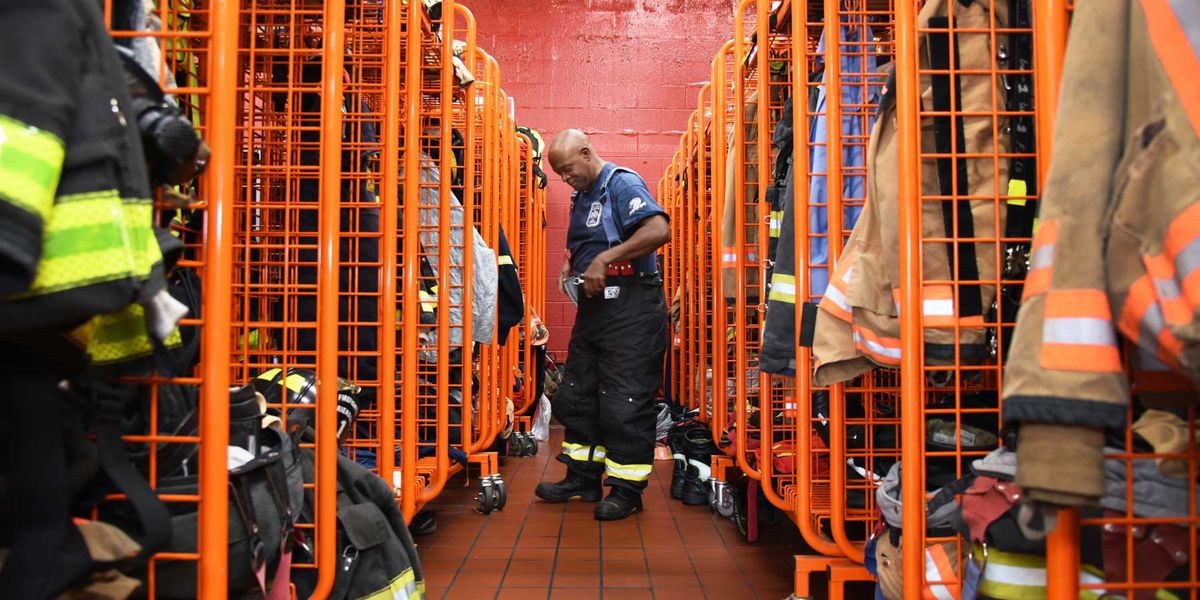 Photo of firefighter putting on gear