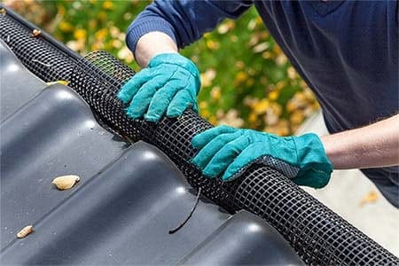 photo of a man adding gutter guards