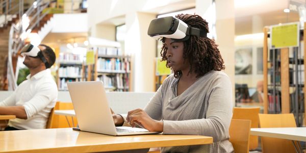 Photo of a person using VR while using a laptop