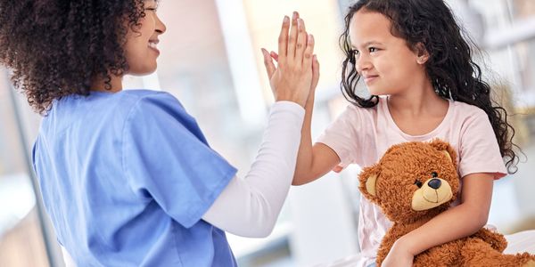 Photo of a pediatric nurse with a child