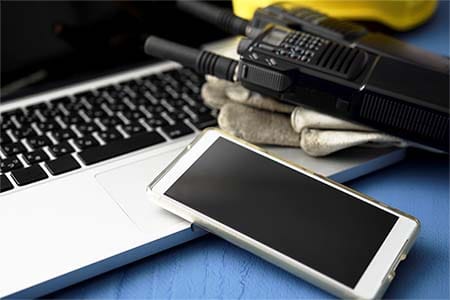 a 2-way radio, cell phone and laptop