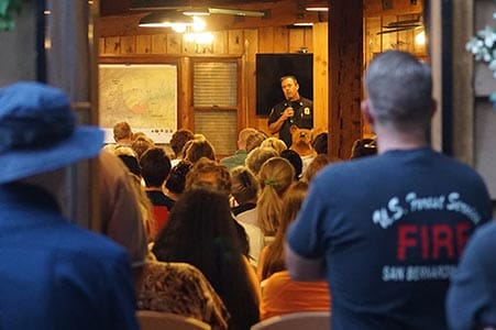 firefighter addressing a community meeting